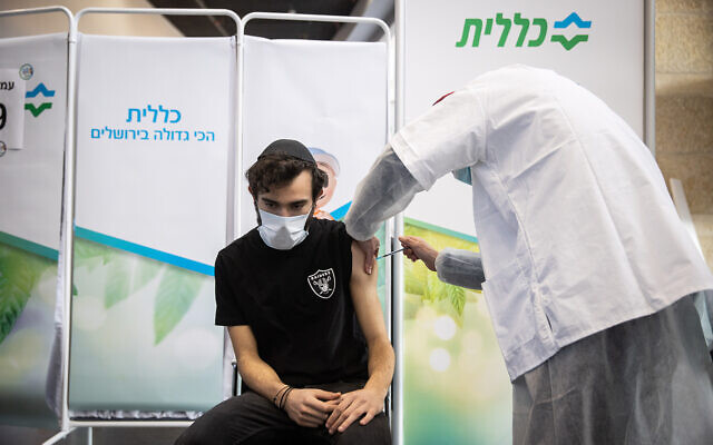 An Israeli receives a COVID-19 vaccine, at Clalit vaccination center in Jerusalem, on March 8, 2021. (Yonatan Sindel/Flash90) An Israeli receives a COVID-19 vaccine, at Clalit vaccination center in Jerusalem, on March 8, 2021. (Yonatan Sindel/Flash90)