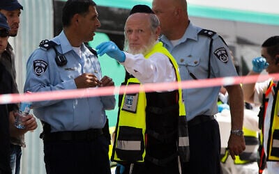Yehuda Meshi-Zahav, then head of Israel's ZAKA rescue service, center, stands stands at the scene of a shooting attack by a Palestinian gunman, in Jerusalem, Oct. 13, 2015. (AP Photo Oded Balilty, File)
