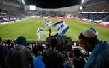 Israeli fans cheer before the World Cup 2022 group F qualifying soccer match between Israel and Denmark in Tel Aviv, March 25, 2021. (AP Photo/Ariel Schalit)