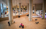 Passengers walk in the arrivals hall at the Ben Gurion International Airport near Tel Aviv on March 8, 2021. (Avshalom Sassoni/ Flash90)