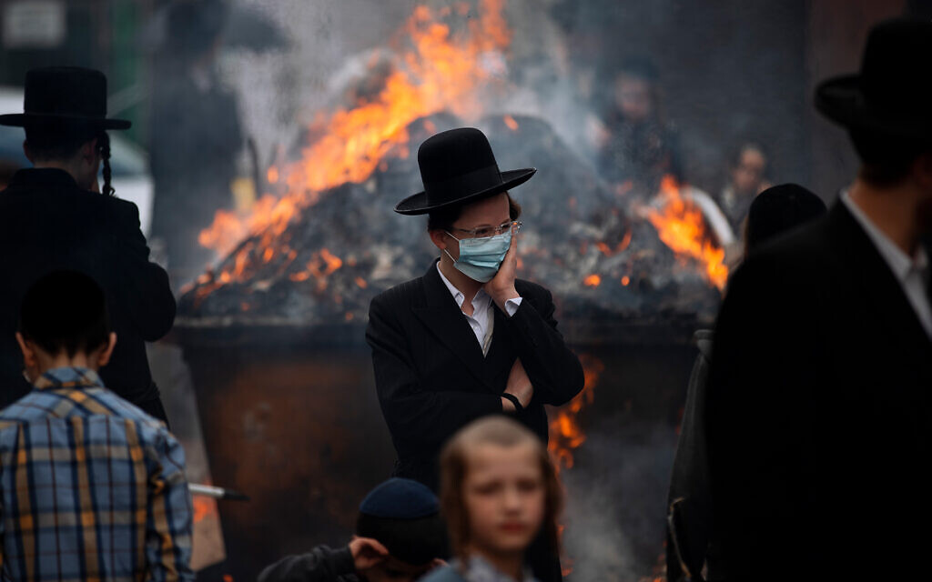 Ultra-Orthodox men and children burn leavened items in final preparation for the Passover holiday in the ultra-Orthodox town of Bnei Brak, near Tel Aviv,, March 26, 2021. (AP Photo/Oded Balilty)