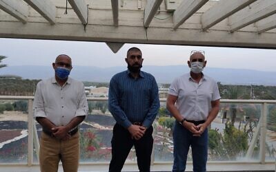 (L-R) Yesha Council director Yigal Dilmoni, Palestinian Workers Association chair Muhammad Arif Masad and Yesha Council chair David Elhayani in the Jordan Valley on March 15, 2021. (Yesha Council)