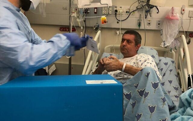 A patient casts a ballot from bed at Tel Aviv Sourasky Medical Center on March 23, 2021 (courtesy of Tel Aviv Sourasky Medical Center)