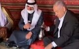 Prime Ministher Benjamin Netanyahu pours coffee for Bedouin leaders in southern Israel during a visit with members of the community, March 7, 2021. (video screenshot)