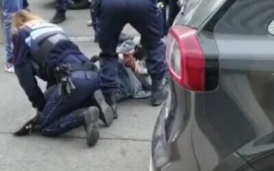 Police arrest a man armed with a knife outside a Jewish school and kosher market in Marseille, France, March 5, 2021 (video screenshot)