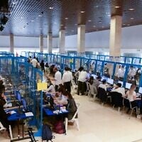 Officials during the process of counting the Knesset election absentee ballots at the Central Elections Committee in Jerusalem, March 24, 2021. (Rafi Ben Hakun/GPO)
