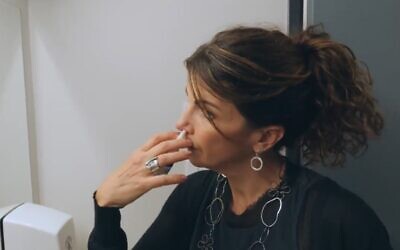 Gilly Regev, an Israeli-raised scientist who co-founded the company SaNOtize, uses the new nasal spray she developed (Screen grab)