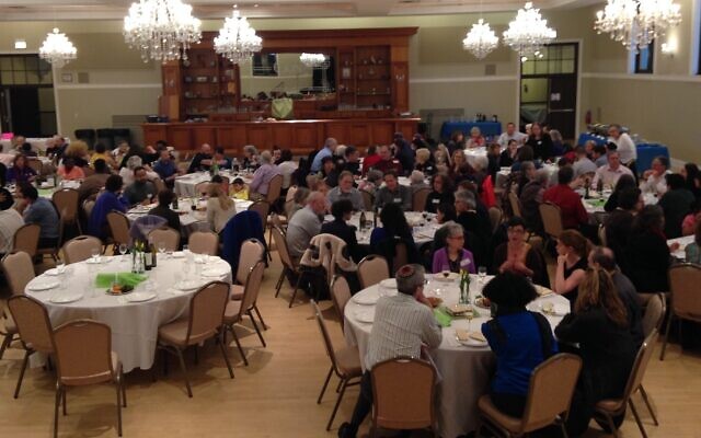Members of Tzedek Chicago hold a Passover seder in 2018. (Courtesy of Tzedek Chicago, via JTA)