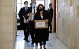 State attorneys carry boxes of files into a hearing in Prime Minister Benjamin Netanyahu's corruption trial at Jerusalem District Court on April 5, 2021. (POOL / AFP)