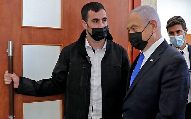 Prime Minister Benjamin Netanyahu leaves the courtroom at Jerusalem District Court on April 5, 2021, during his corruption trial. (Abir SULTAN / POOL / AFP)