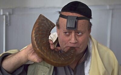 Afghan Jew Zebulon Simentov blows a shofar horn at a synagogue housed in an old building in Kabul, April 5, 2021. (WAKIL KOHSAR / AFP)