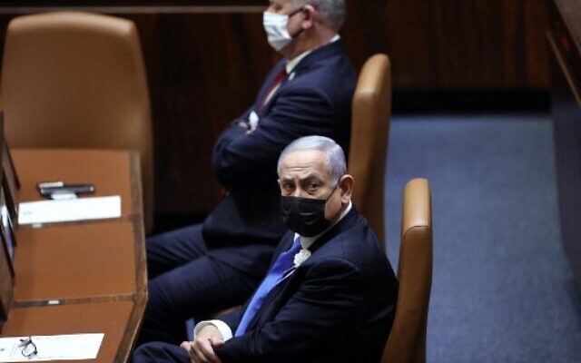 Prime Minister Benjamin Netanyahu (R) and Defense Minister Benny Gantz attend the swearing-in ceremony of Israel's Knesset (parliament) in Jerusalem, on April 6, 2021. (Alex Kolomoisky / POOL / AFP) Prime Minister Benjamin Netanyahu (R) and Defense Minister Benny Gantz attend the swearing-in ceremony of Israel's Knesset (parliament) in Jerusalem, on April 6, 2021. (Alex Kolomoisky / POOL / AFP)