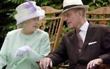 In this file photo taken on July 17, 2002, Britain's Queen Elizabeth II and Britain's Prince Philip, Duke of Edinburgh chat while seated during a musical performance in the Abbey Gardens, Bury St Edmunds, during her Golden Jubilee visit to Suffolk, east of England. (Fiona HANSON / POOL / AFP)