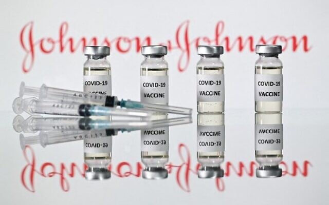 In this file illustration picture taken on November 17, 2020 shows vials with Covid-19 Vaccine stickers attached and syringes with the logo of US pharmaceutical company Johnson & Johnson. - The EU's drug regulator said April 9, 2021 it had launched a review of possible links between the Johnson & Johnson coronavirus vaccine and blood clots after reports of four cases, one of them fatal. (Photo by JUSTIN TALLIS / AFP) In this file illustration picture taken on November 17, 2020 shows vials with Covid-19 Vaccine stickers attached and syringes with the logo of US pharmaceutical company Johnson & Johnson. - The EU's drug regulator said April 9, 2021 it had launched a review of possible links between the Johnson & Johnson coronavirus vaccine and blood clots after reports of four cases, one of them fatal. (Photo by JUSTIN TALLIS / AFP)