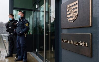 Illustrative: Two judicial officers stand in front of the Higher Regional court in Dresden, eastern Germany, April 12, 2021. (JENS SCHLUETER / AFP)