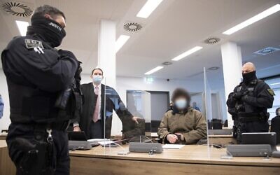 Defendant Abdullah A (C), accused of stabbing a German tourist to death in Dresden, sits next to judicial officials and his lawyer Peter Hollstein (2ndL) at the start of his trial at the Higher Regional Court in Dresden, eastern Germany, on April 12, 2021 (Sebastian Kahnert / POOL / AFP)