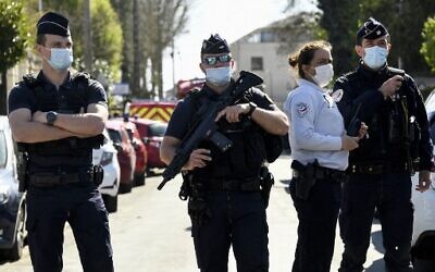French police officials block off a street near the police station in Rambouillet, south-west of Paris, on April 23, 2021, after a woman was stabbed to death. (Bertrand Guay/AFP)