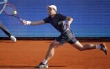 Russia's Aslan Karatsev plays a forehand return to Serbia's Novak Djokovic during their ATP 250 Serbia Open semi-final singles tennis match at The Novak Tennis Centre in Belgrade on April 24, 2021. (PEDJA MILOSAVLJEVIC / AFP)