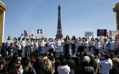 Members of the support committee of late Sarah Halimi gather to ask justice on Trocadero plaza in front of the Eiffel Tower in Paris on April 25, 2021.  (Photo by GEOFFROY VAN DER HASSELT / AFP)