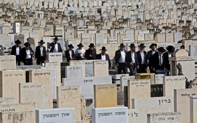Mourners attend the funeral of one of the victims of the deadly Meron crush at Segula cemetery in Petah Tikva on April 30, 2021.(GIL COHEN-MAGEN / AFP)