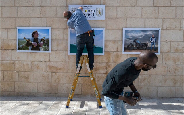 Hanging photographic portraits of Holocaust survivors that are part of The Lonka Project being exhibited in Safra Square in Jerusalem, opening April 8, 2021, Yom HaShaoh, Israeli Heroes and Martyrs remembrance day, and will run for four months, until at least August 2021 (Courtesy The Lonka Project) Hanging photographic portraits of Holocaust survivors that are part of The Lonka Project being exhibited in Safra Square in Jerusalem, opening April 8, 2021, Yom HaShaoh, Israeli Heroes and Martyrs remembrance day, and will run for four months, until at least August 2021 (Courtesy The Lonka Project)