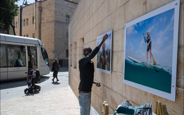 Hanging photographic portraits of Holocaust survivors that are part of The Lonka Project being exhibited in Safra Square in Jerusalem, opening April 8, 2021, Yom HaShaoh, Israeli Heroes and Martyrs remembrance day, and will run for four months, until at least August 2021 (Courtesy The Lonka Project) Hanging photographic portraits of Holocaust survivors that are part of The Lonka Project being exhibited in Safra Square in Jerusalem, opening April 8, 2021, Yom HaShaoh, Israeli Heroes and Martyrs remembrance day, and will run for four months, until at least August 2021 (Courtesy The Lonka Project)