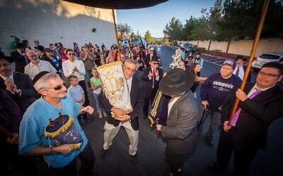 Members of the Ahavas Torah Center in Henderson parade through the city during a Torah dedication ceremony in the mid-2010s. The Las Vegas suburb is home to a growing Orthodox Jewish population. (Courtesy of Ahavas Torah Center/ via JTA)