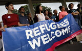 Activists hold a banner during a pro-refugee demonstration organized by HIAS outside the US Capitol, September 14, 2017. (Aaron P. Bernstein/Getty Images/ via JTA/ SUE)