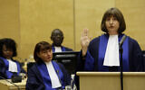 Silvia Fernandez De Gurmendi from Argentina takes the oath during a swearing-in ceremony as a new judge of the International Criminal Court (ICC), at the seat of the Court in The Hague, Netherlands, Wednesday, Jan. 20, 2010. (AP Photo/ Bas Czerwinski)