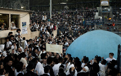 Ultra-Orthodox Jews take part in prayers on the grave of Rabbi Shimon Bar Yochai during Lag B'Omer celebrations at Mt. Meron in northern Israel, early Thursday, May 10, 2012. (AP Photo/Ariel Schalit)