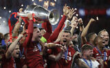 Liverpool's players celebrate with the trophy after winning the Champions League final soccer match between Tottenham Hotspur and Liverpool at the Wanda Metropolitano Stadium in Madrid on June 2, 2019. (AP Photo/Felipe Dana)