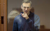 FILE: Russian opposition leader Alexei Navalny gestures during a hearing on his charges for defamation in the Babuskinsky District Court in Moscow, Russia, February 16, 2021. (Babuskinsky District Court Press Service via AP)