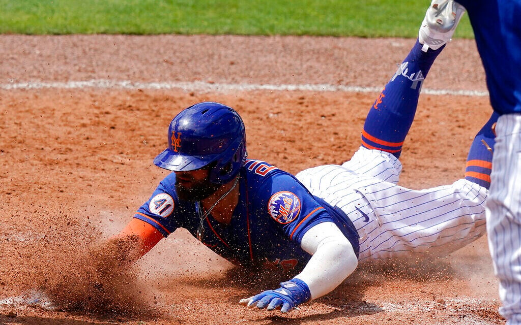 New York Mets' Kevin Pillar is out stealing home during the fourth inning of a spring training baseball game against the Miami Marlins, March 23, 2021, in Port St. Lucie, Florida. (AP Photo/Lynne Sladky)