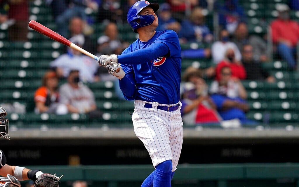 Chicago Cubs' Joc Pederson watches his two run home run take flight during the first inning of a spring training baseball game against the San Francisco Giants, March 26, 2021, in Mesa, Arizona. (AP Photo/Matt York)