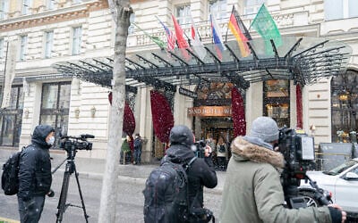 Journalists wait in front of the Grand Hotel Wien where closed-door nuclear talks with Iran take place in Vienna, Austria, Tuesday, April 6, 2021. (AP Photo/Florian Schroetter)
