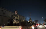 In this November 28, 2019, file photo armed soldiers stand guard in the motorcade for US President Donald Trump speaks during a surprise Thanksgiving Day visit to the troops at Bagram Air Field, Afghanistan. (AP/Alex Brandon, File)