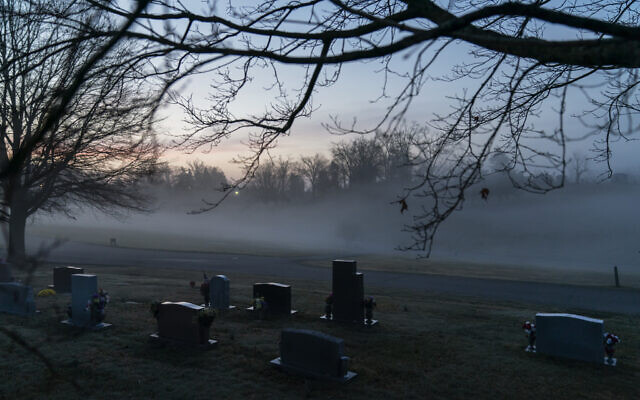 In this Wednesday, March 17, 2021 file photo, morning fog blankets a cemetery in West Virginia. The number of U.S. suicides fell nearly 6% in 2020 amid the coronavirus pandemic — the largest annual decline in at least four decades, according to preliminary government data. (AP Photo/David Goldman) In this Wednesday, March 17, 2021 file photo, morning fog blankets a cemetery in West Virginia. The number of U.S. suicides fell nearly 6% in 2020 amid the coronavirus pandemic — the largest annual decline in at least four decades, according to preliminary government data. (AP Photo/David Goldman)