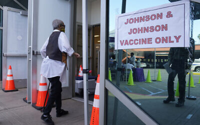 In this April 1, 2021 photo, people walk in to get their COVID-19 vaccine at the Baldwin Hills Crenshaw Plaza in Los Angeles. (AP Photo/Damian Dovarganes)