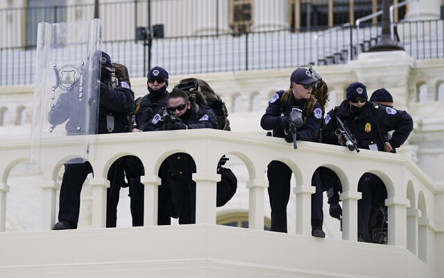 Police keep a watch on demonstrators who tried to break through a police barrier at the Capitol in Washington, January 6, 2021. (AP Photo/Julio Cortez, File) Police keep a watch on demonstrators who tried to break through a police barrier at the Capitol in Washington, January 6, 2021. (AP Photo/Julio Cortez, File)