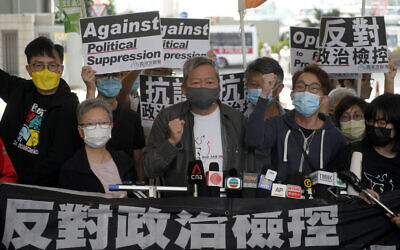 Pro-democracy activist Lee Cheuk-yan, center, arrives at a court in Hong Kong Friday, April 16, 2021. (AP Photo/Kin Cheung)