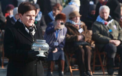 Then-Polish Prime Minister Beata Szydlo lights a candle at the International Monument to the Victims of Fascism, after a ceremony marking the 72nd anniversary of the liberation of the German Nazi death camp Auschwitz-Birkenau, in Oswiecim, Poland, January 27, 2017. (AP Photo/Czarek Sokolowski, file)
