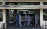 In this April 13, 2021 file photo, the body of a person who died of COVID-19 is brought for cremation at the Vasai crematory in Palghar, near Mumbai, India (AP Photo/Rajanish Kakade)