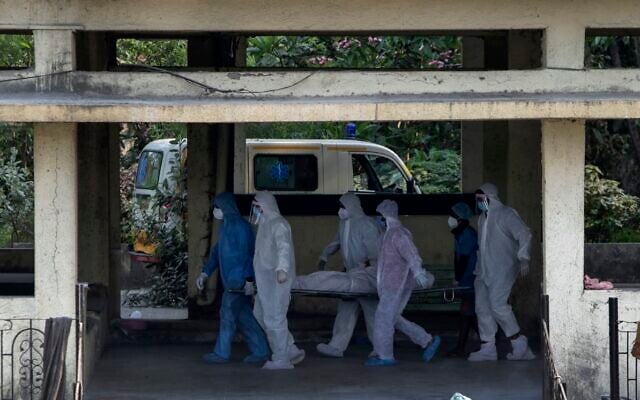 In this April 13, 2021 file photo, the body of a person who died of COVID-19 is brought for cremation at the Vasai crematory in Palghar, near Mumbai, India (AP Photo/Rajanish Kakade) In this April 13, 2021 file photo, the body of a person who died of COVID-19 is brought for cremation at the Vasai crematory in Palghar, near Mumbai, India (AP Photo/Rajanish Kakade)