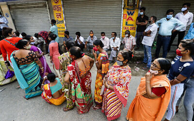 Voters  wait to cast their votes during the fifth phase of West Bengal state elections in Newtown Rajarhat, North 24 Parganas district, India, April 17, 2021. (Bikas Das/AP)