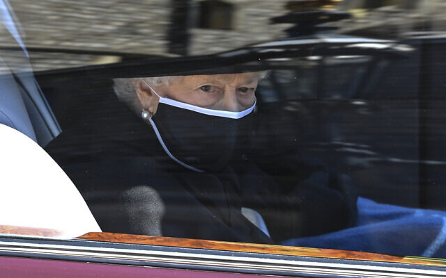 Britain's Queen Elizabeth II follows the coffin in a car as it makes it's way past the Round Tower during the funeral of Britain's Prince Philip inside Windsor Castle in Windsor, England Saturday April 17, 2021. (Leon Neal/Pool via AP)