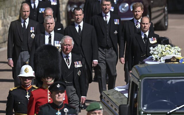 From front left, Britain's Prince Charles, Prince Andrew. Prince Edward, Prince William, Peter Phillips, Prince Harry, Earl of Snowdon and Tim Laurence follow the coffin the coffin makes it's way past the Round Tower during the funeral of Britain's Prince Philip inside Windsor Castle in Windsor, England Saturday April 17, 2021. (Leon Neal/Pool via AP)