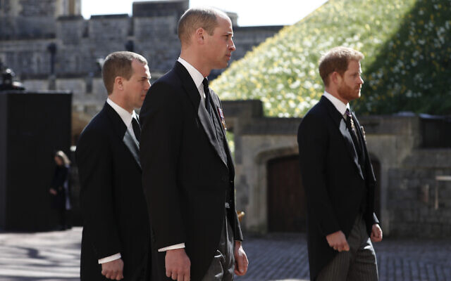 Britain's Prince Harry, right, Prince William, Peter Phillips, left, follow the coffin in a ceremonial procession for the funeral of Britain's Prince Philip inside Windsor Castle in Windsor, England Saturday April 17, 2021. (Alastair Grant/Pool via AP)