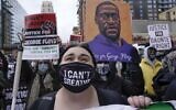 Protesters rally outside the 3rd Precinct on April 19, 2021, in Minneapolis as the murder trial against the former Minneapolis police officer Derek Chauvin in the killing of George Floyd advanced to jury deliberations. (AP Photo/Morry Gash)