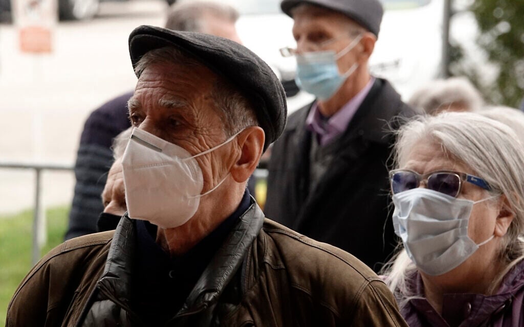 People wait for a COVID-19 vaccine, at a sports hall in the capital Sarajevo, Bosnia, Wednesday, April 21, 2021. (AP Photo/Eldar Emric)