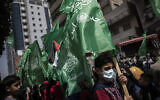 Palestinians holding Hamas movement green flags attend a protest in solidarity with Muslim worshipers in Jerusalem, in Gaza City, April 23, 2021. (AP Photo/Khalil Hamra)